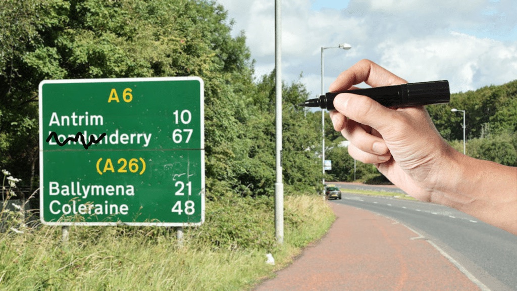 A road sign reading Londonderry with the London prefix scored out by hand